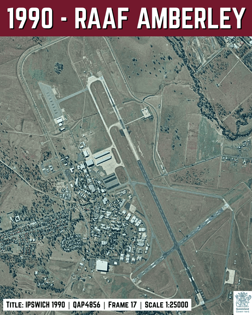 1990 aerial image of RAAF Amberley showing expanded support areas and hangar clusters around the established airfield, Ipswich region QLD